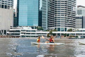 Family kayaking along the Brisbane River